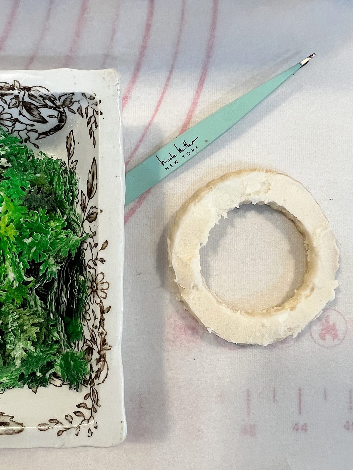 Homemade sugar cookies with buttercream frosting decorated with wafer paper wreaths.