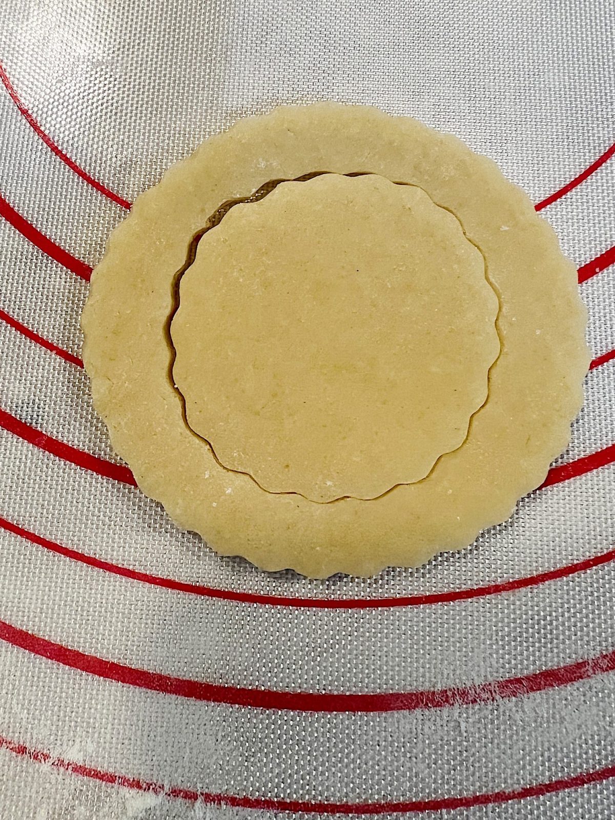 Homemade sugar cookies with buttercream frosting decorated with wafer paper wreaths.