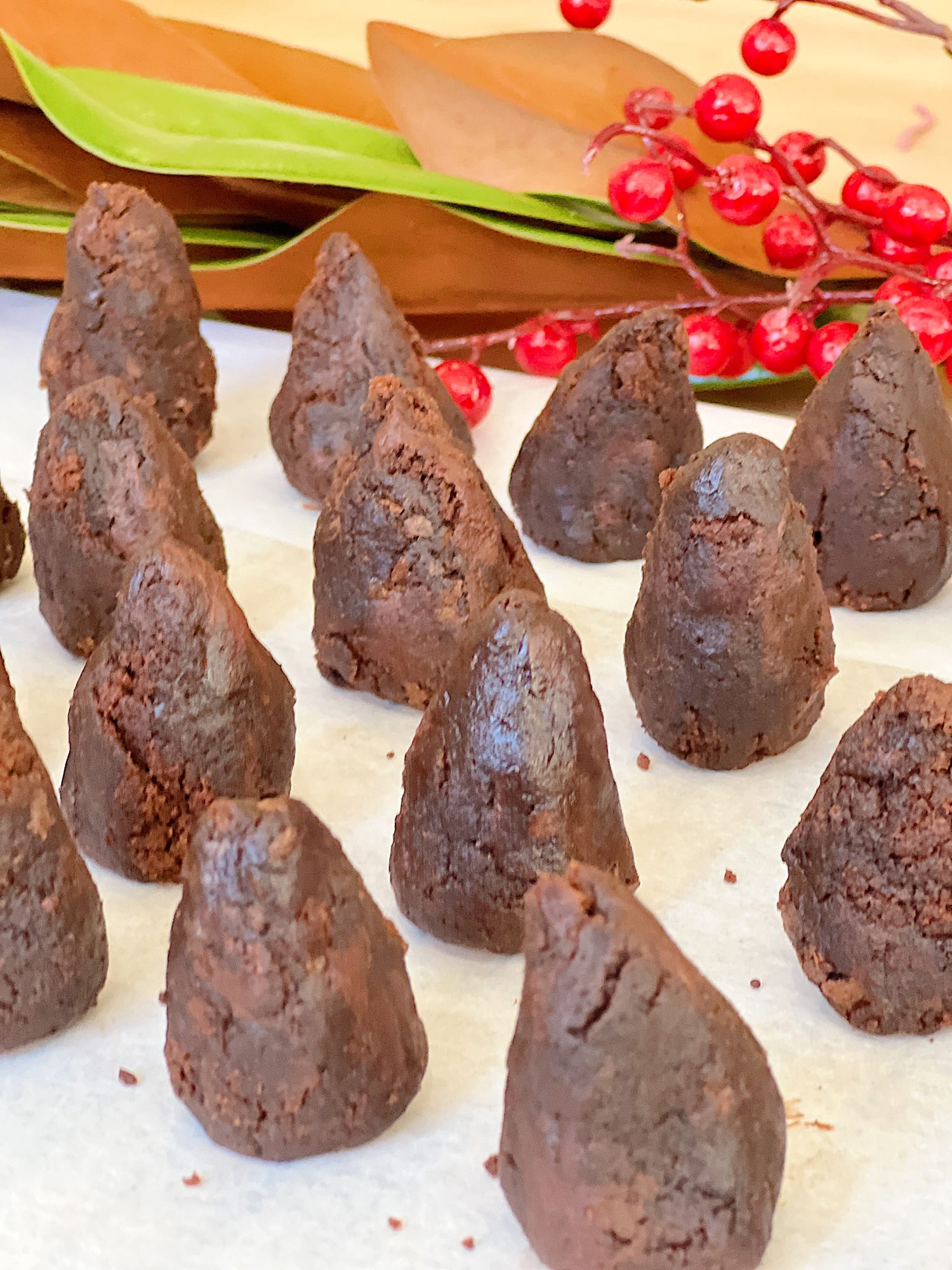 Homemade white chocolate covered brownie pinecones made from brownies, almonds, and melted chocolate.