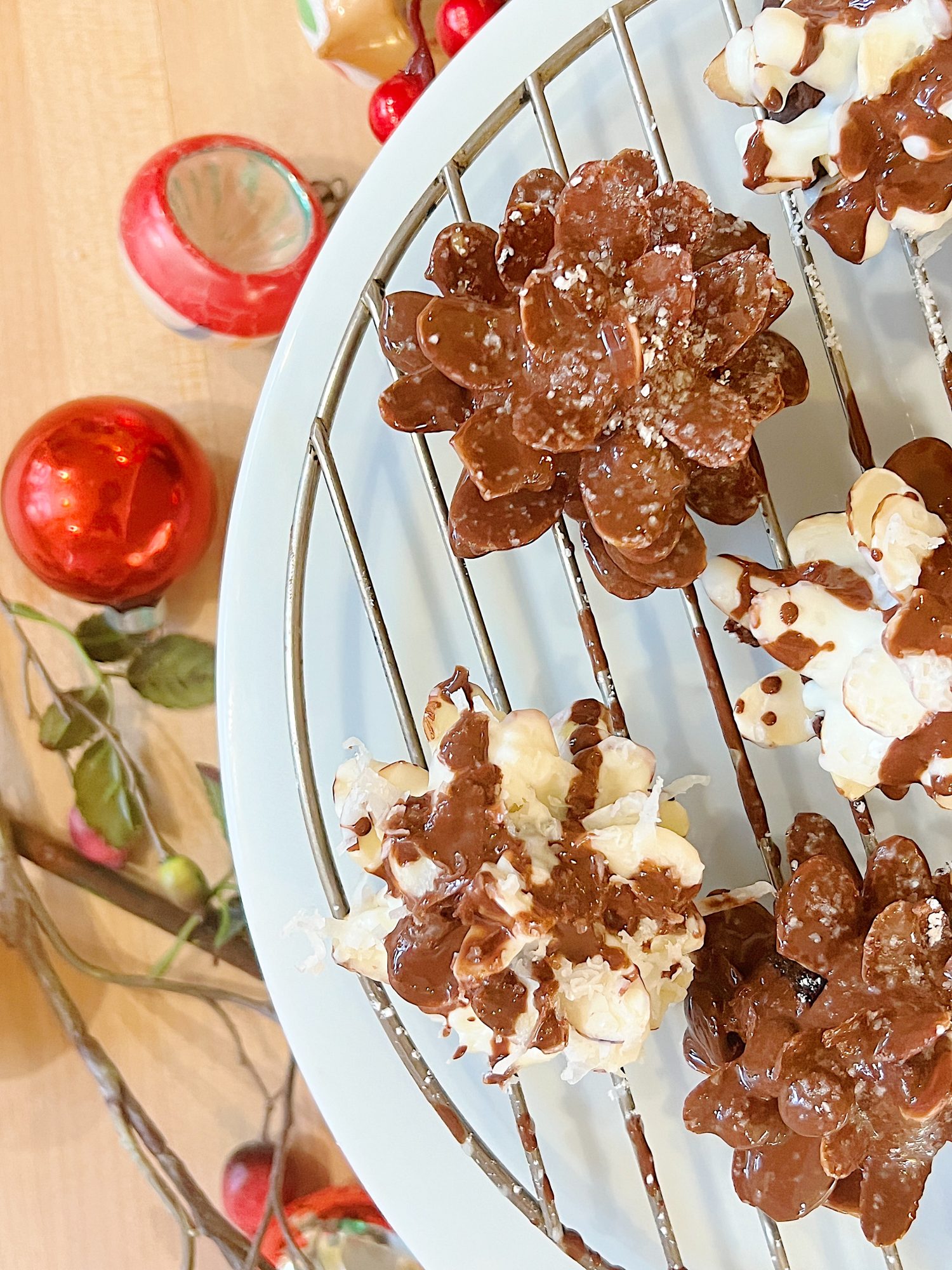 Homemade white chocolate covered brownie pinecones made from brownies, almonds, and melted chocolate.