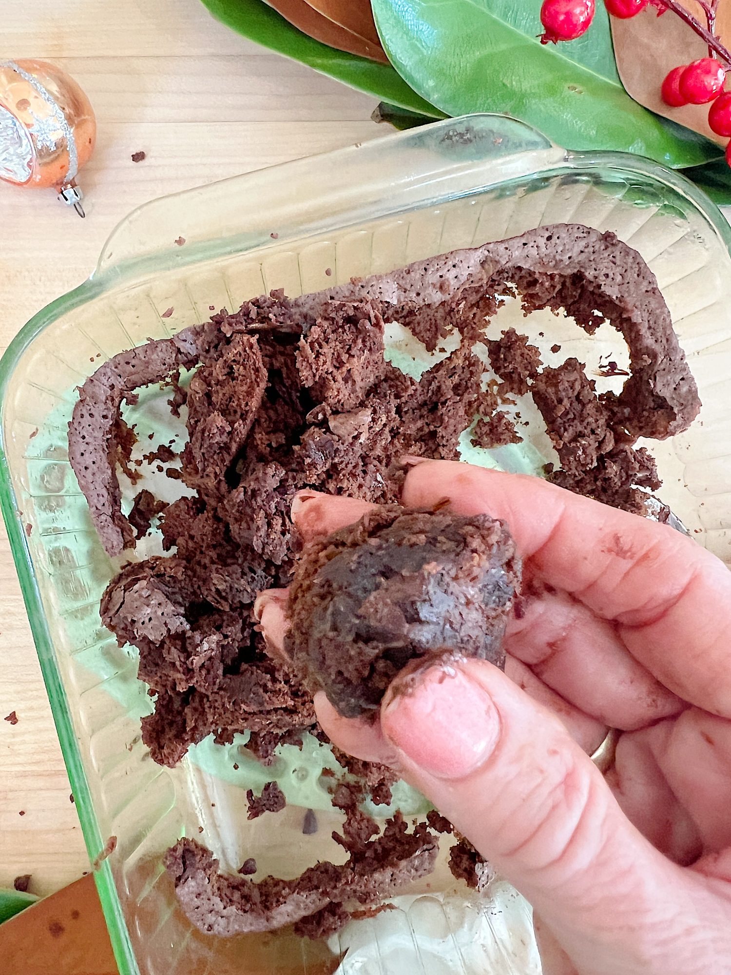 Homemade white chocolate covered brownie pinecones made from brownies, almonds, and melted chocolate.