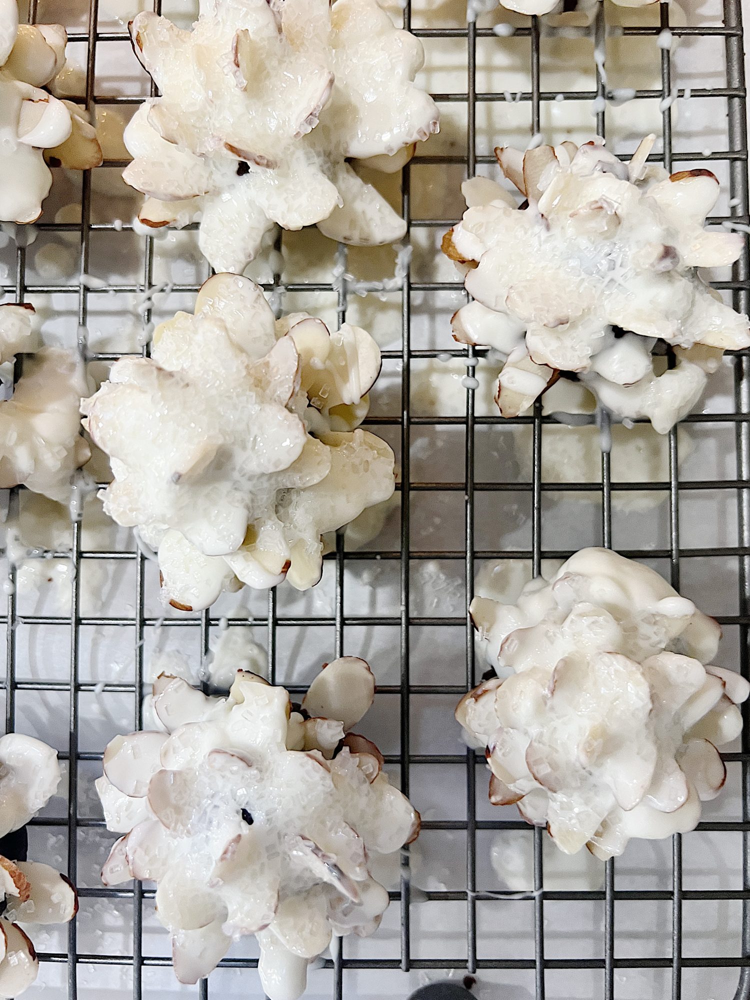 Homemade white chocolate covered brownie pinecones made from brownies, almonds, and melted chocolate.