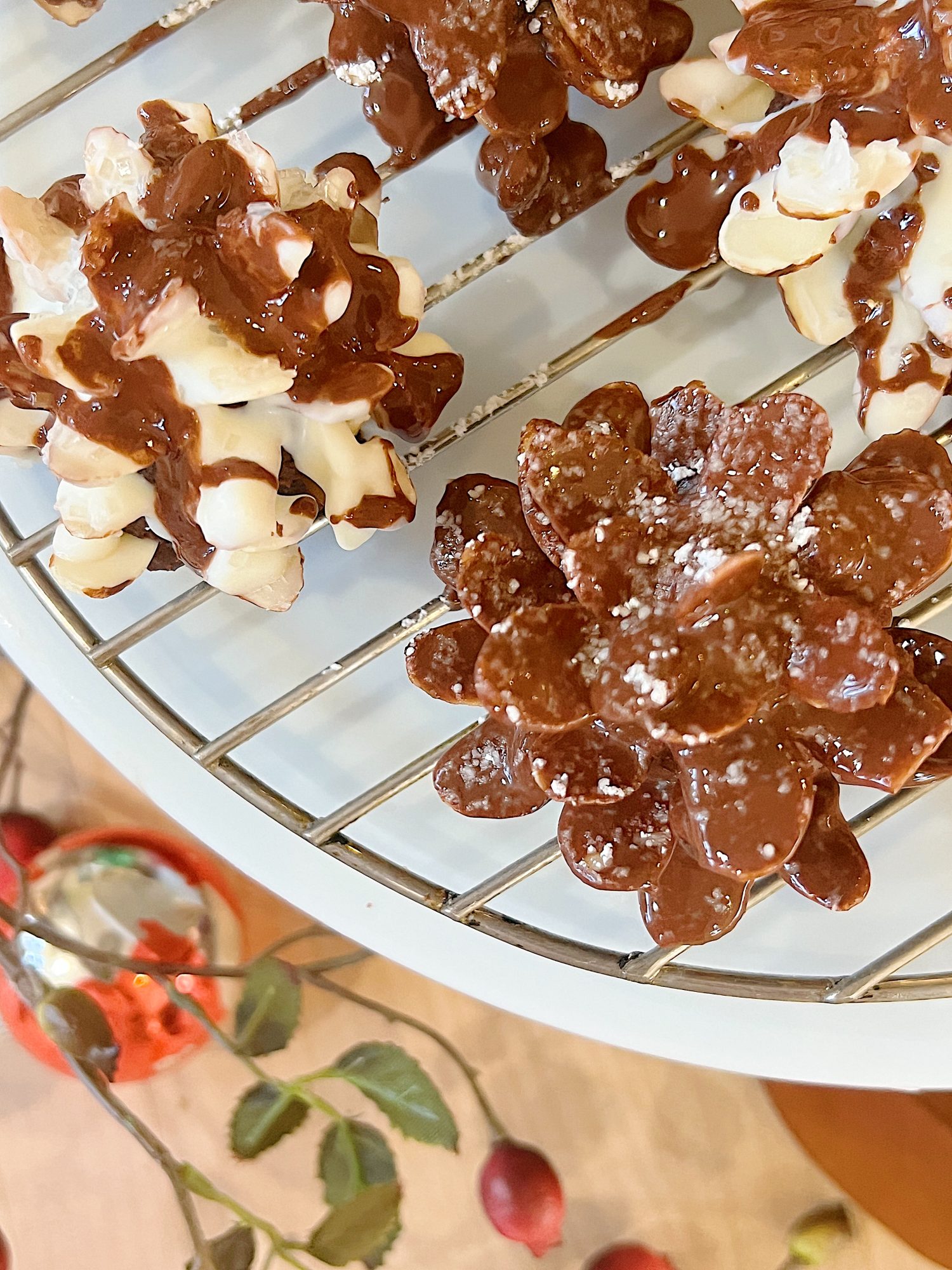 Homemade white chocolate covered brownie pinecones made from brownies, almonds, and melted chocolate.