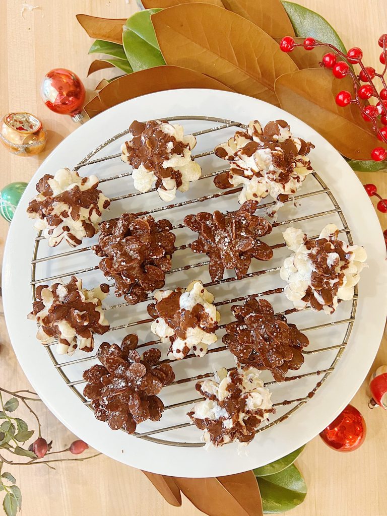 Homemade white chocolate covered brownie pinecones made from brownies, almonds, and melted chocolate.