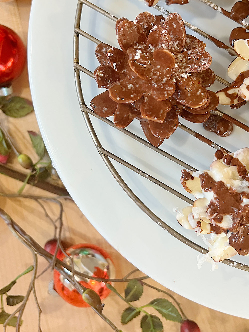 Homemade white chocolate covered brownie pinecones made from brownies, almonds, and melted chocolate.