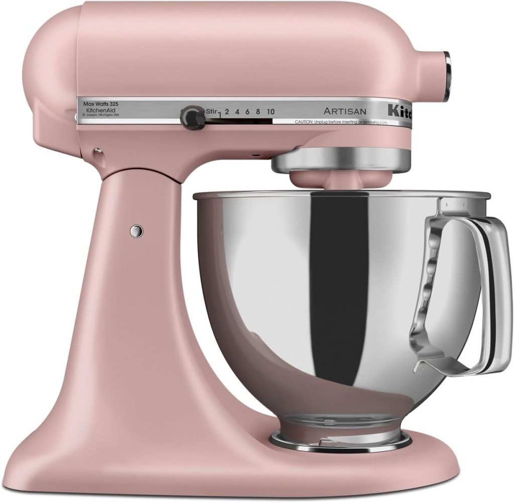 This charming pink KitchenAid stand mixer, perfect for creating a delightful Valentine's Day charcuterie board, features a stainless steel bowl and various speed settings.