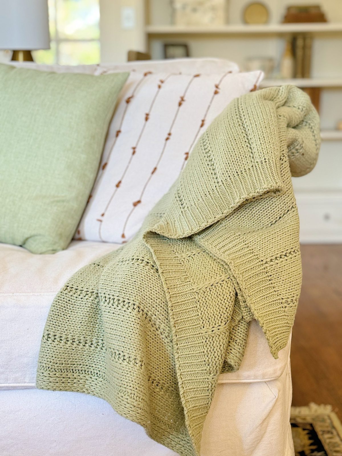A redecorated living room with sage and taupe and a mix of new and vintage items.