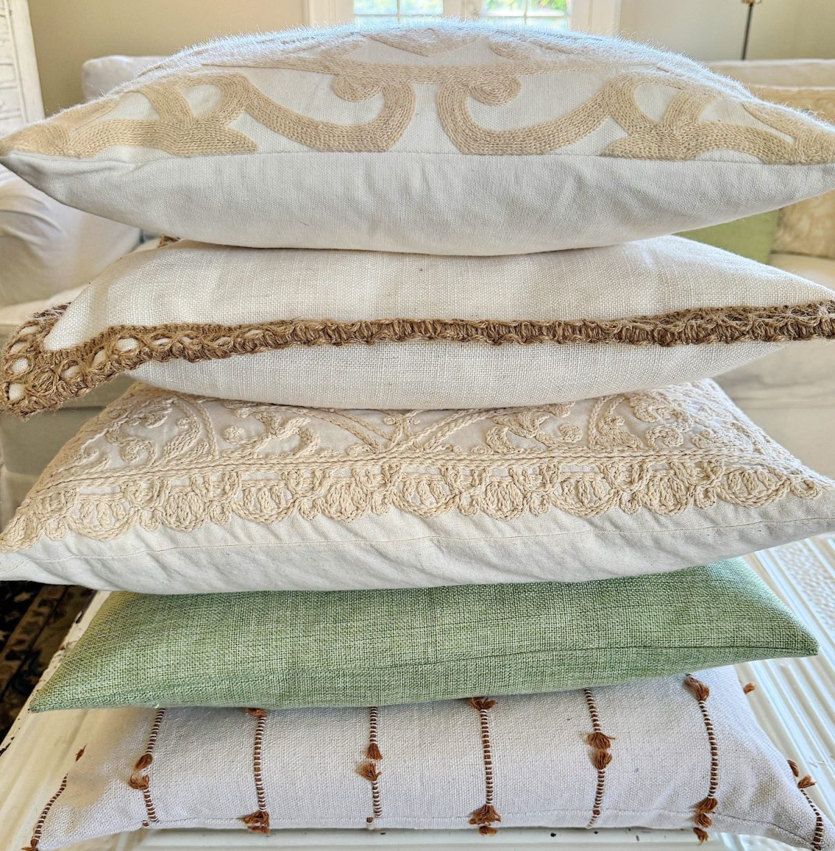 A redecorated living room with sage and taupe and a mix of new and vintage items.