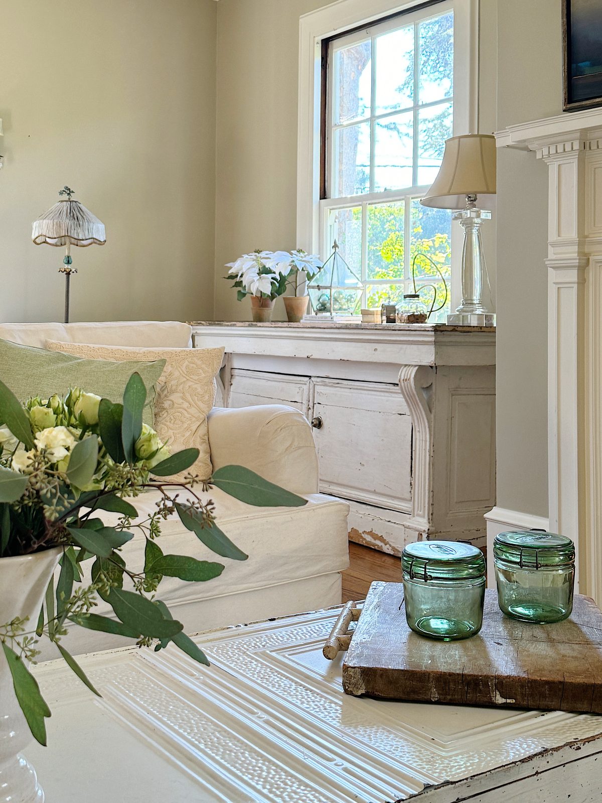 A redecorated living room with sage and taupe and a mix of new and vintage items.