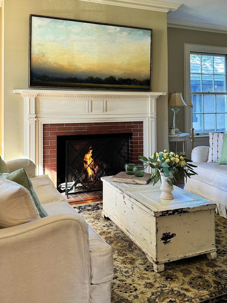 A redecorated living room with sage and taupe and a mix of new and vintage items.