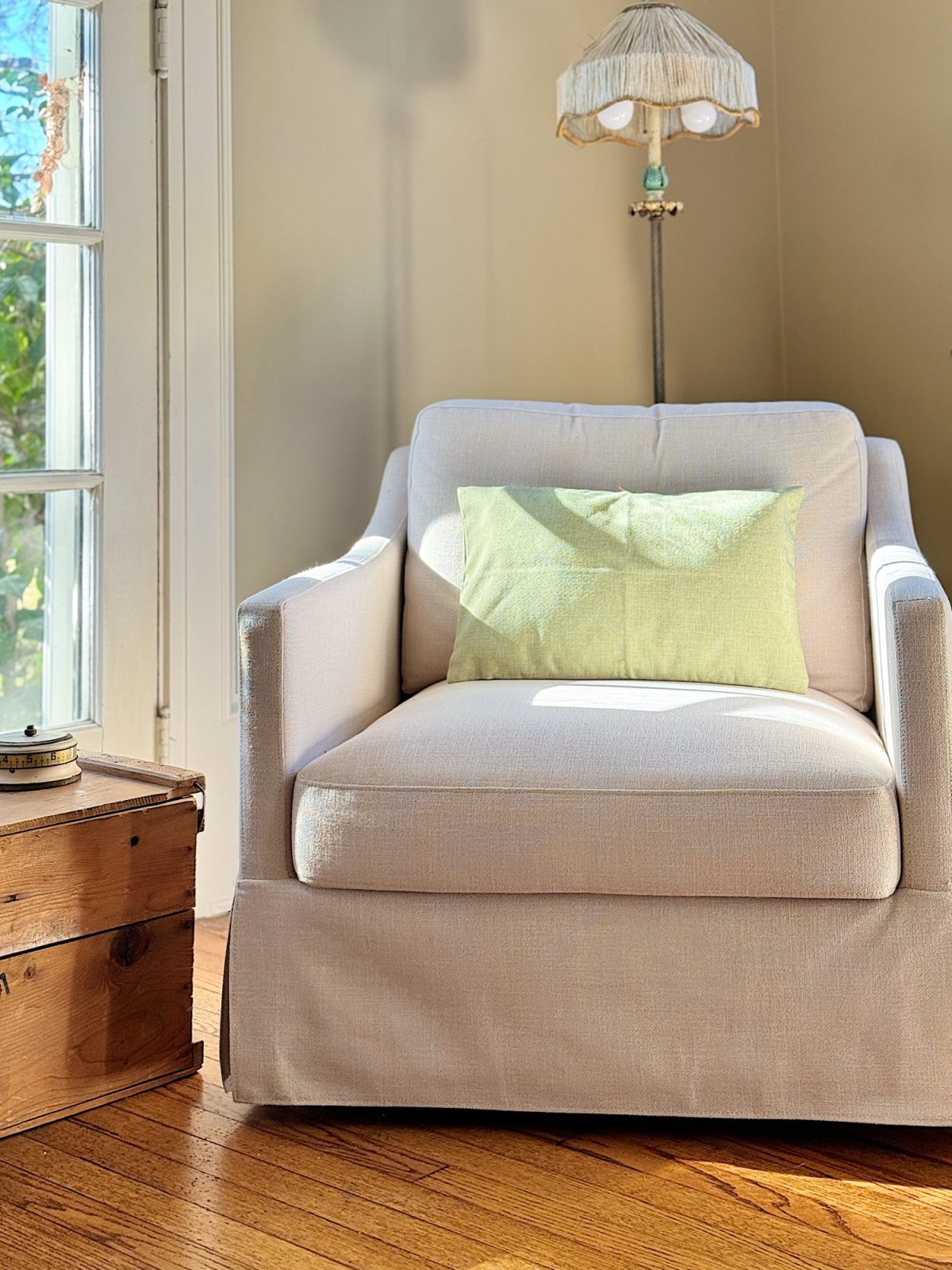 A redecorated living room with sage and taupe and a mix of new and vintage items.