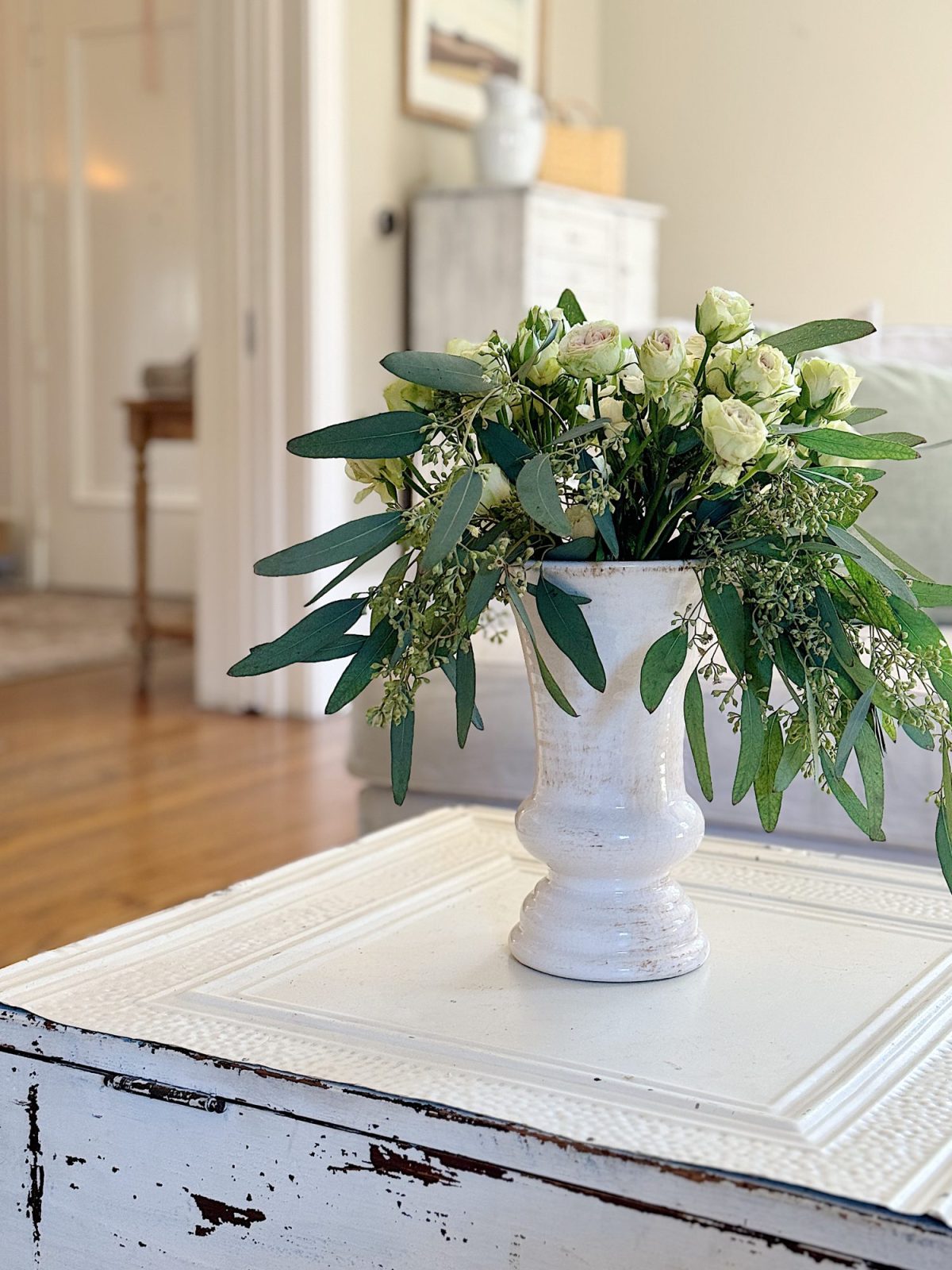 A redecorated living room with sage and taupe and a mix of new and vintage items.