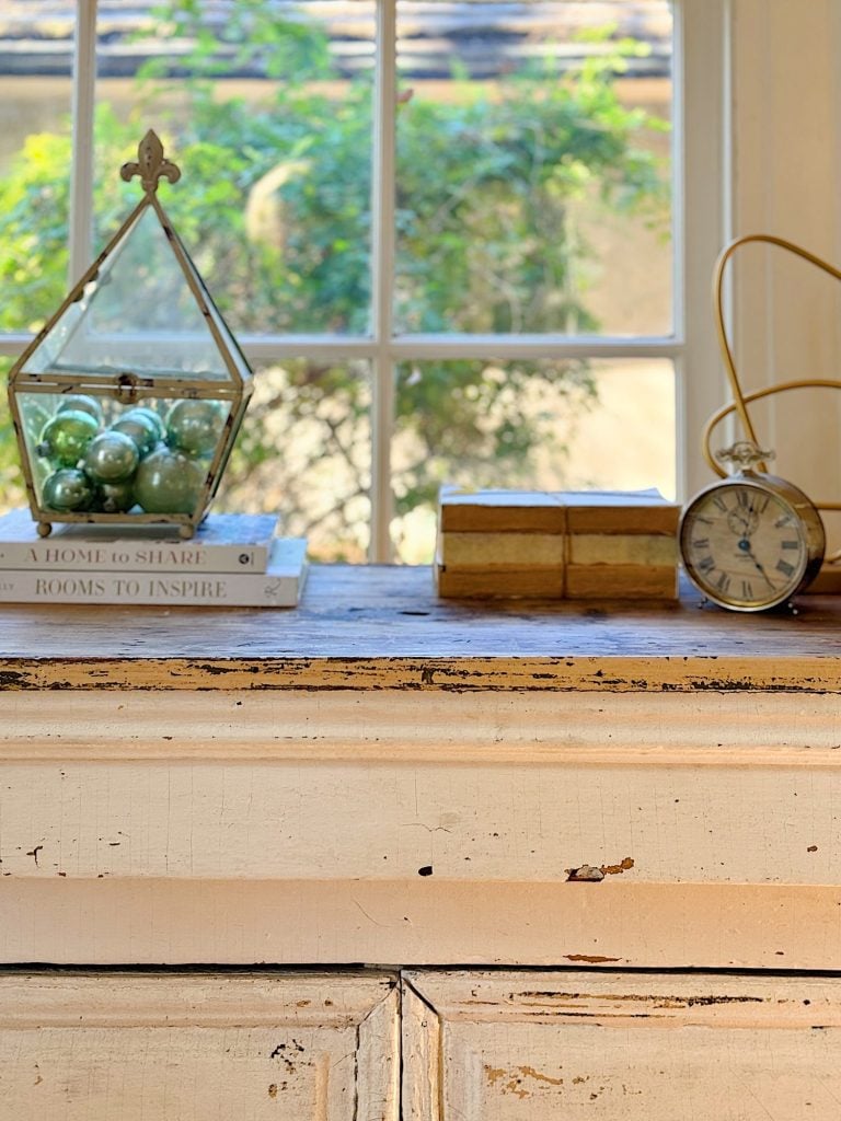 A redecorated living room with sage and taupe and a mix of new and vintage items.