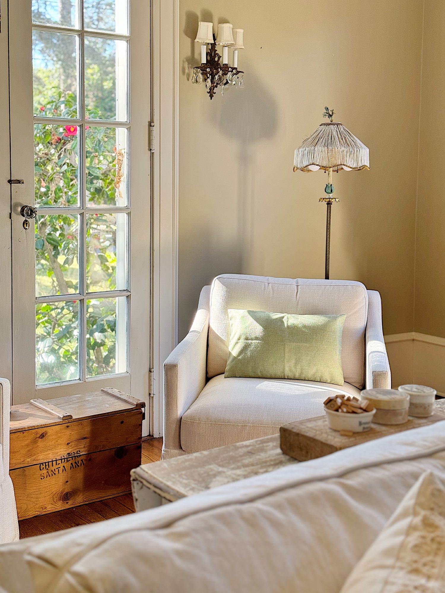 A redecorated living room with sage and taupe and a mix of new and vintage items.