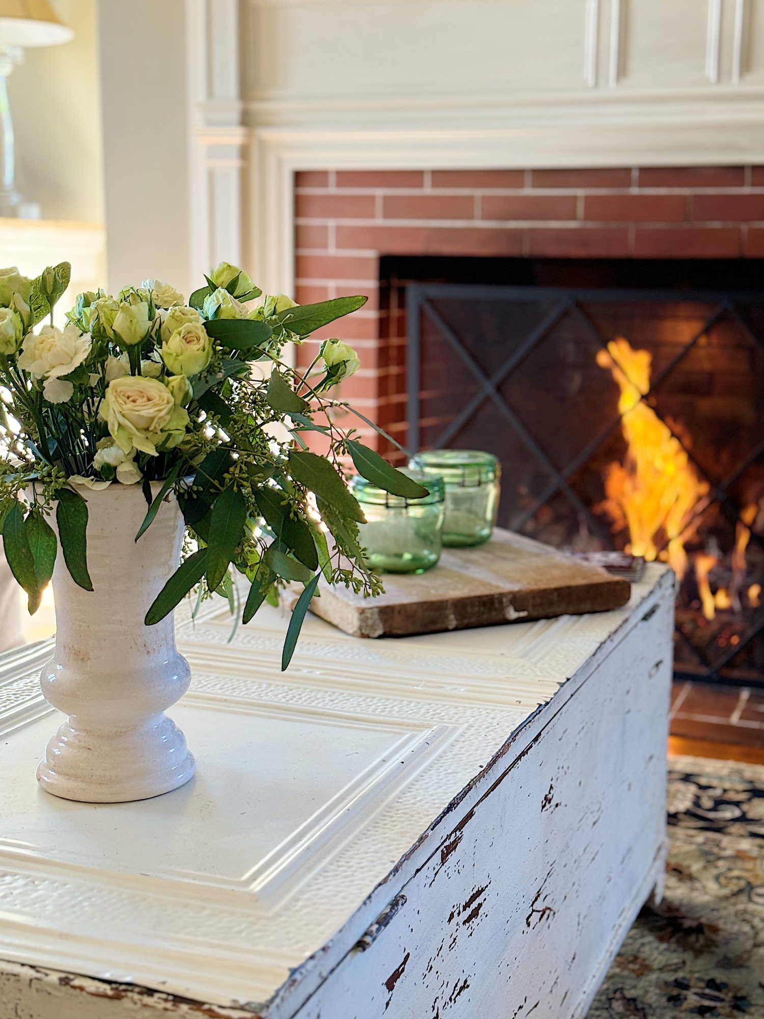 A redecorated living room with sage and taupe and a mix of new and vintage items.