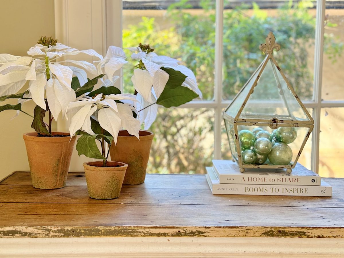 A redecorated living room with sage and taupe and a mix of new and vintage items.