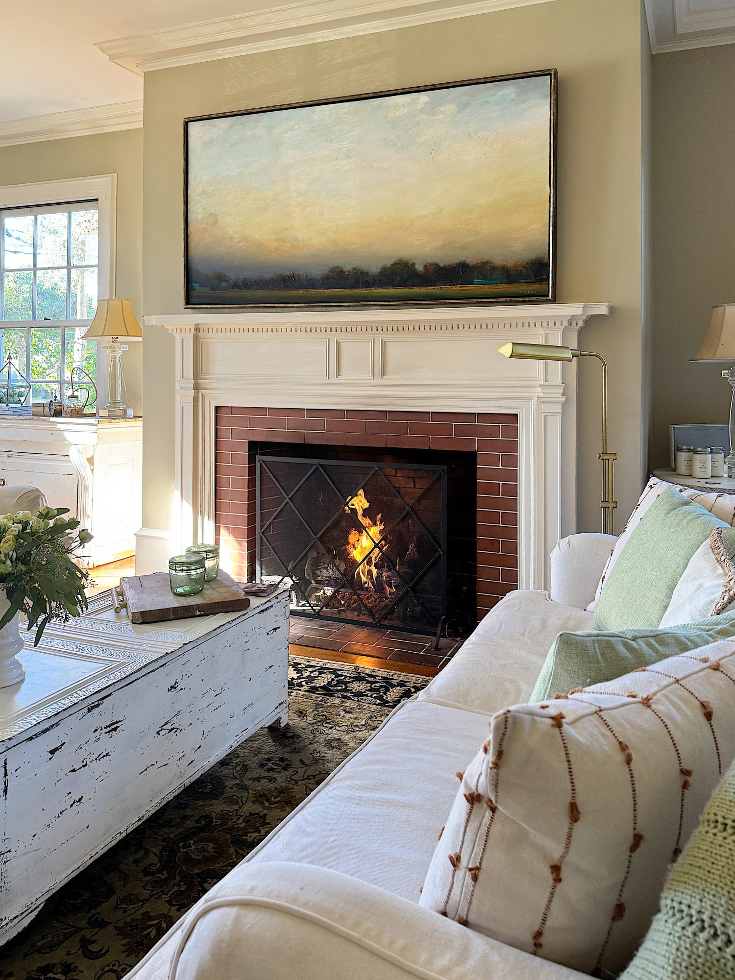 A redecorated living room with sage and taupe and a mix of new and vintage items.
