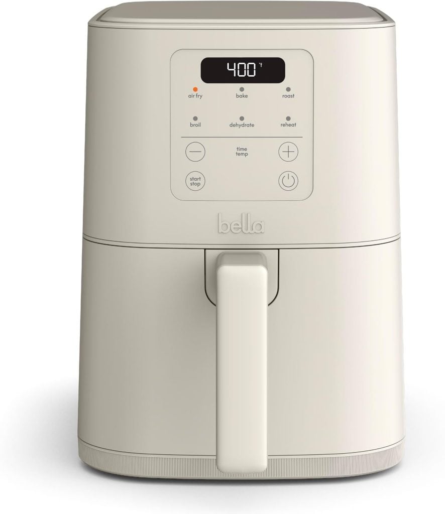 A beige Bella air fryer with a digital display set to 400°F is perfect for preparing delicious meals like baked parmesan crusted chicken. The control panel offers versatile options such as air fry, bake, roast, broil, dehydrate, and reheat.