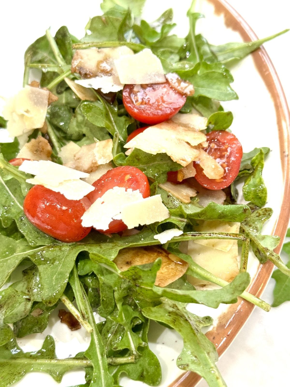 Arugula, tomatoes and shaved parmesan salad