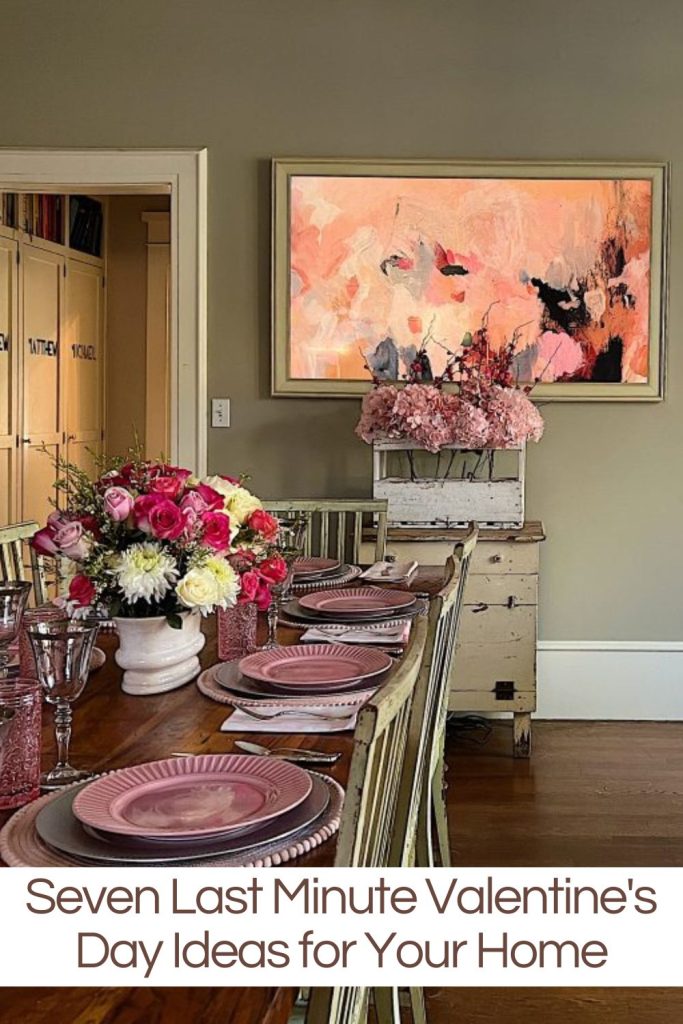 Our family room dining table set for a pink themed Valentine's Day dinner and the Frame TV with a pink and peach modern art design.