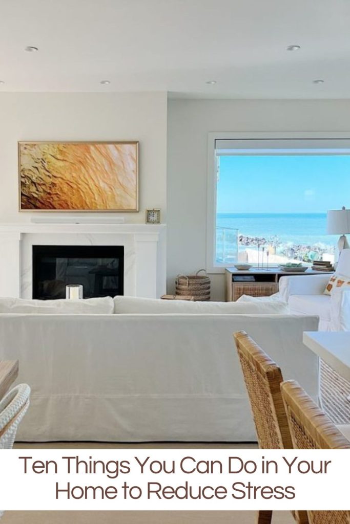 Our Ventura Beach house with art on the Frame TV, an ocean view, and white and tan furniture.