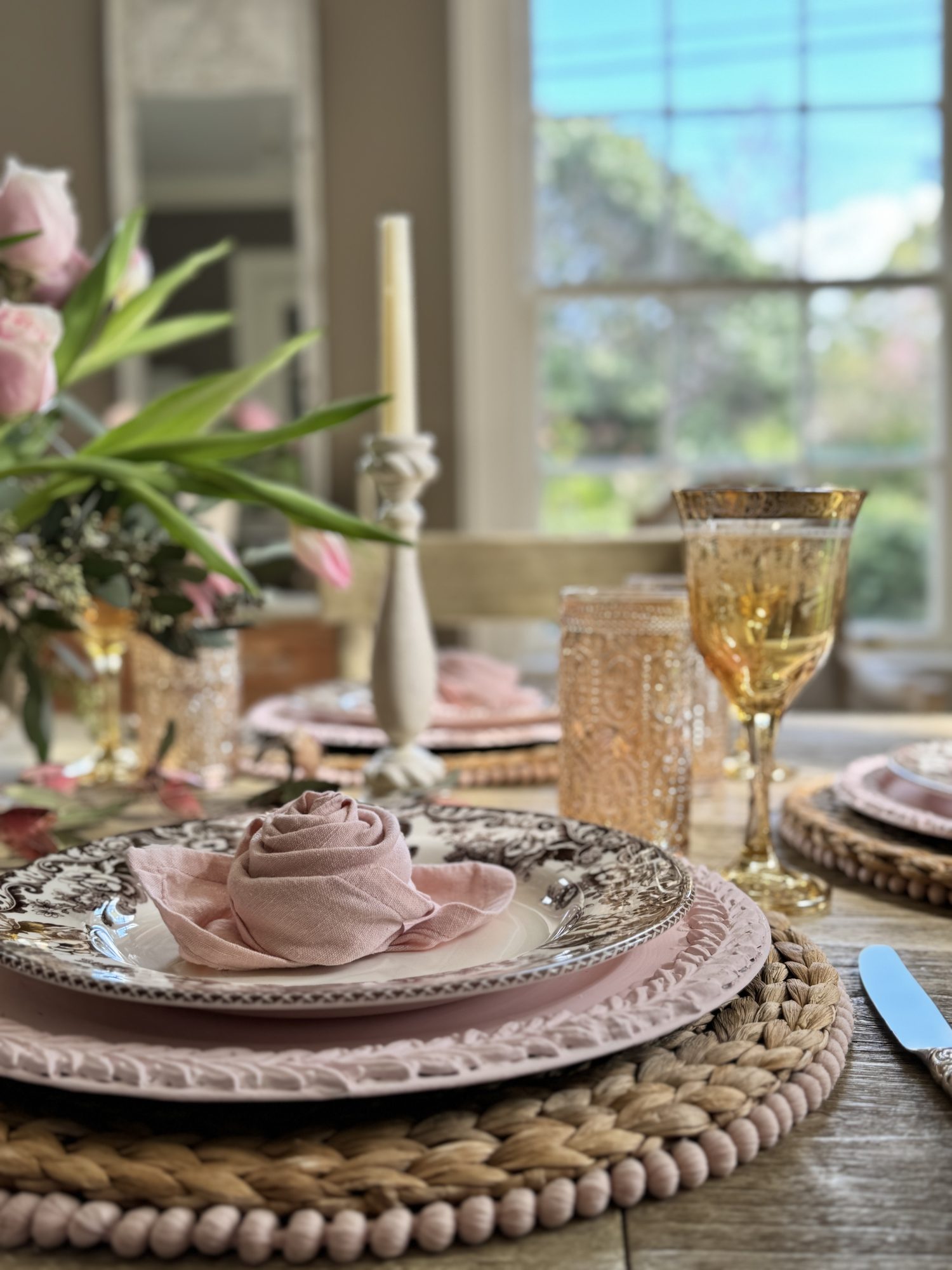 Light pink and tan neutral Valentine's Day Dining Room Table Decor with rosette napkins.