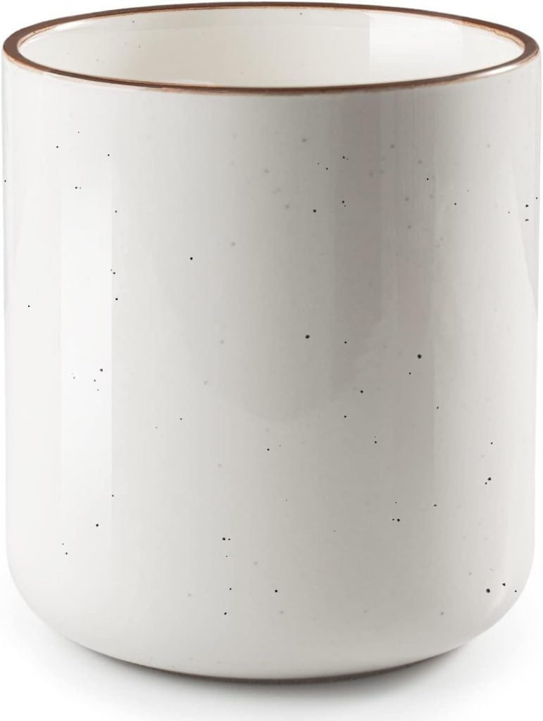 White speckled ceramic mug with a brown rim, featuring spring floral arrangements.