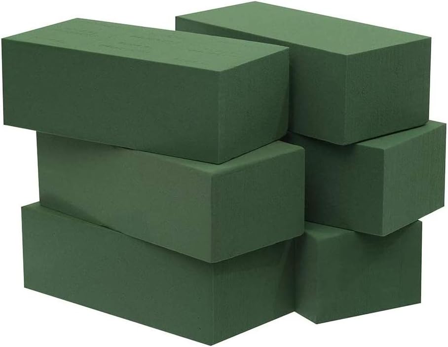 A stack of green yoga blocks at an outdoor party.