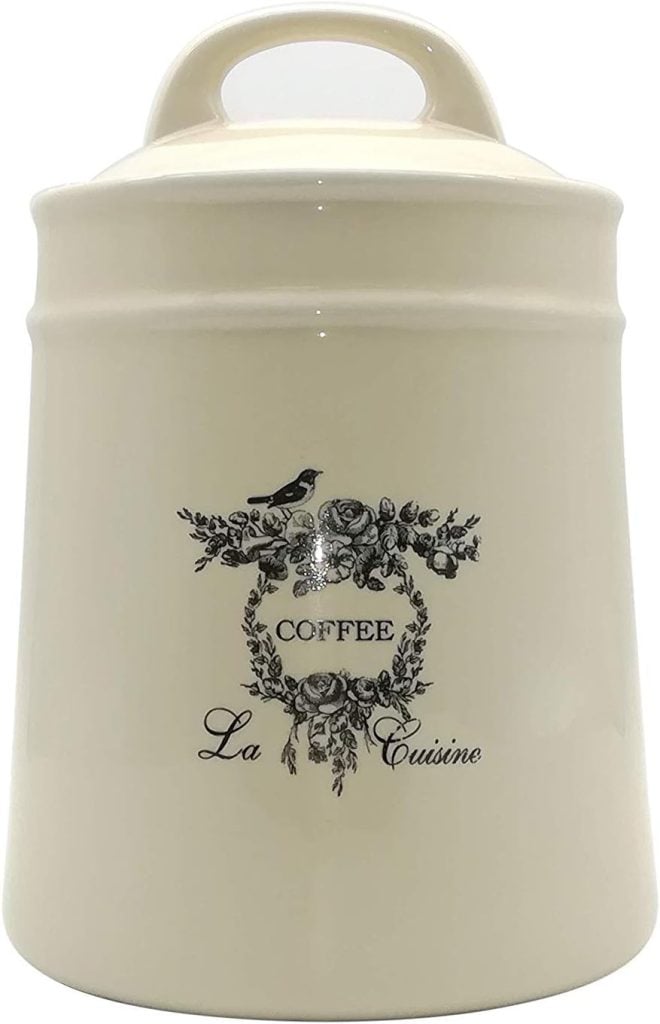 A cream-colored coffee canister with a vintage spring floral label design.