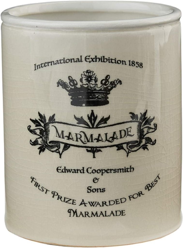 Vintage marmalade jar commemorating an 1858 international exhibition award, adorned with spring floral arrangements.