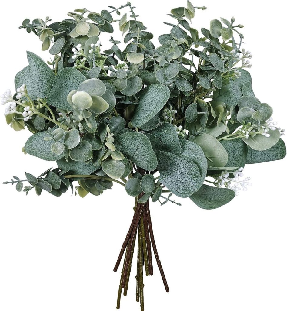 A bouquet of artificial greenery perfect for an outdoor party, with various leaf shapes and small white flowers.