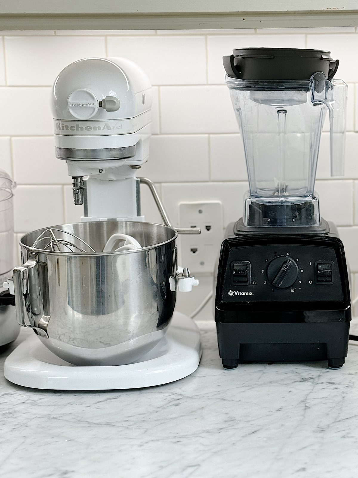 A kitchenaid stand mixer and a vitamix blender on a kitchen counter.