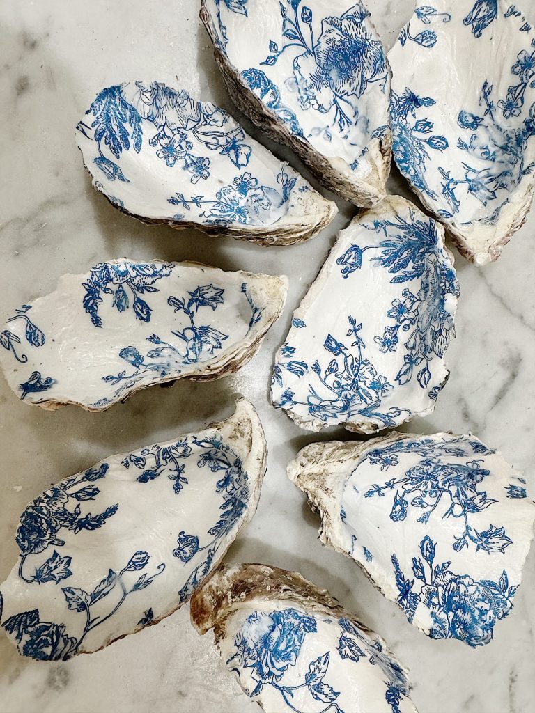 Oyster shells adorned with blue floral napkin patterns.
