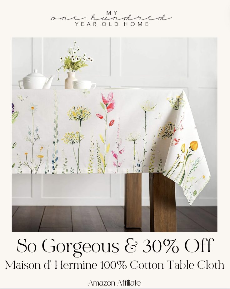 Decorative tablecloth with floral design displayed on a table with teapot set, accompanied by a promotional discount offer.