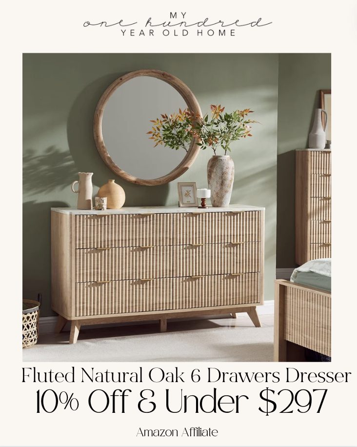 Elegant wooden dresser with a round mirror and decorative items, advertised with a discount from an online retailer.