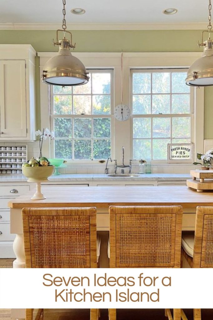 Our kitchen island in our white kitchen with three rattan counter stools.