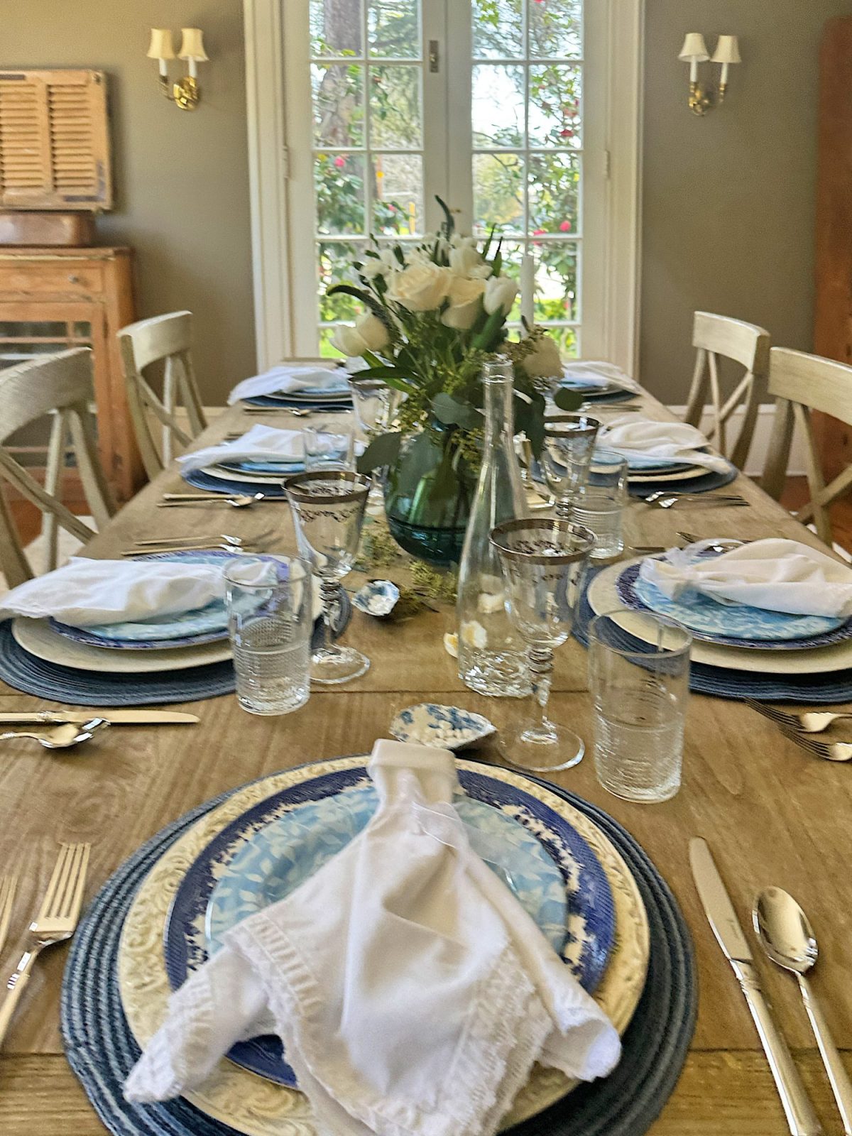 Elegantly set dining table with floral centerpiece ready for a meal.