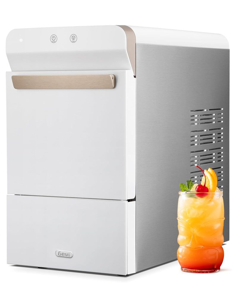 Modern portable ice maker with a glass of fruit juice garnished with a slice of orange and mint leaves, featuring beach decor elements, on a white background.