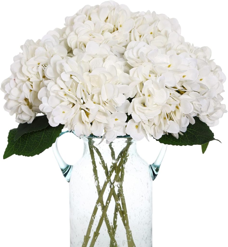 A clear glass vase filled with several white hydrangea flowers and green leaves, perfect for adding a fresh touch to your outdoor porch decor.