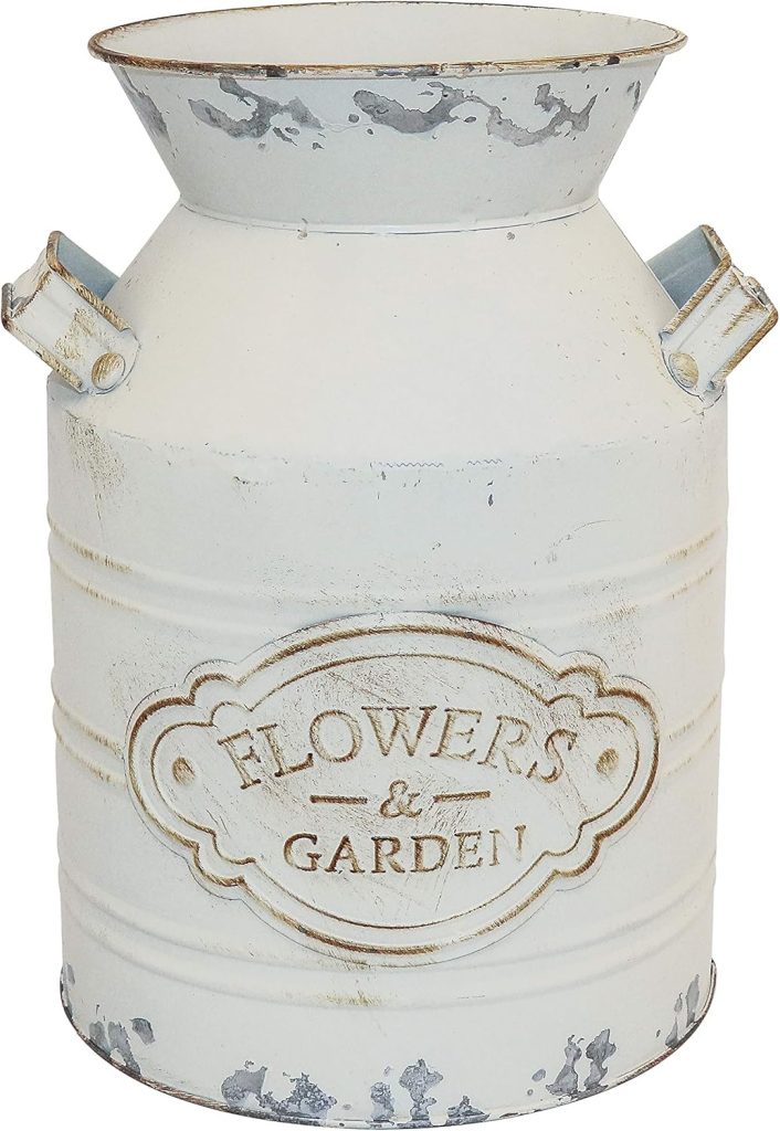 A distressed white metal milk can with handles and an embossed "FLOWERS & GARDEN" label, perfect for adding rustic charm to your outdoor porch decor.
