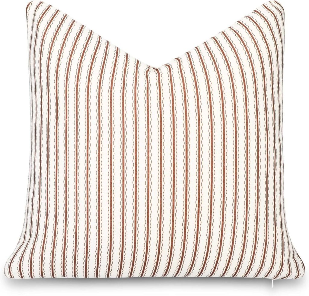 Square pillow with a white background and vertical brown zigzag stripes, perfect for adding a stylish touch to your outdoor porch decor. Shown against a plain white backdrop.