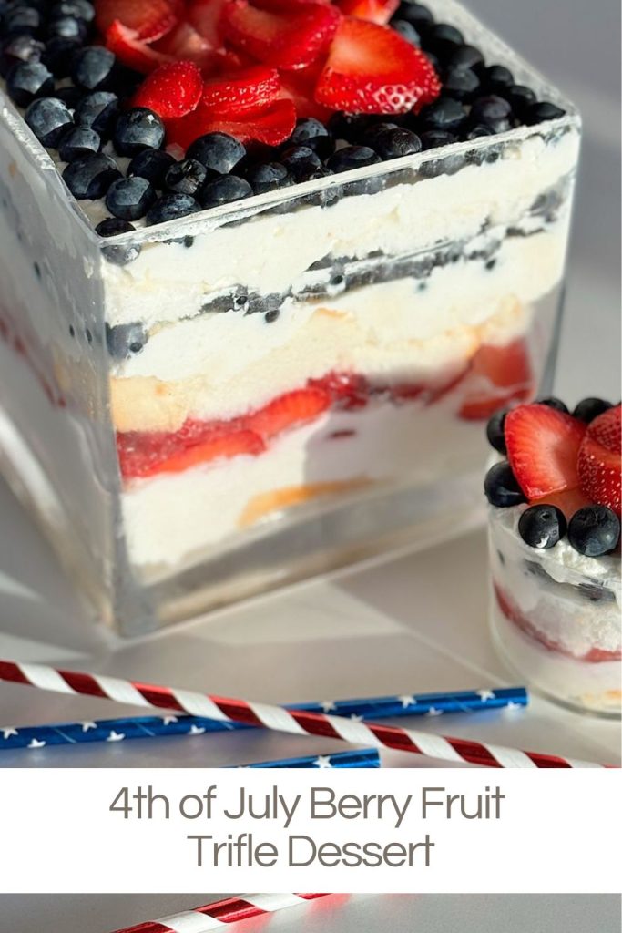 A layered trifle dessert in a square dish, topped with blueberries and strawberries, next to a smaller similar portion and two red, white, and blue straws. Text reads "4th of July Berry Fruit Trifle Dessert.