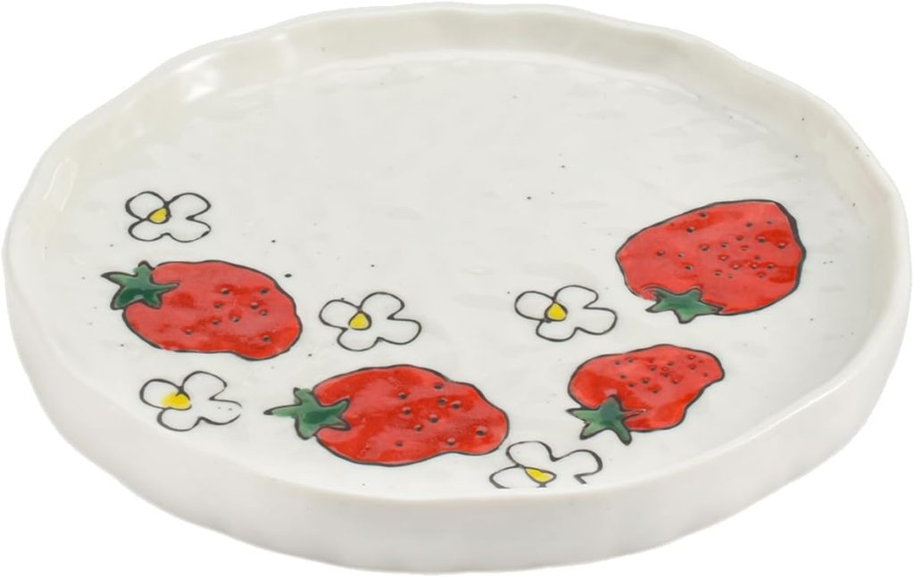 A round white ceramic plate with a wavy edge, decorated with illustrations of mixed berry motifs, including red strawberries and small white flowers.