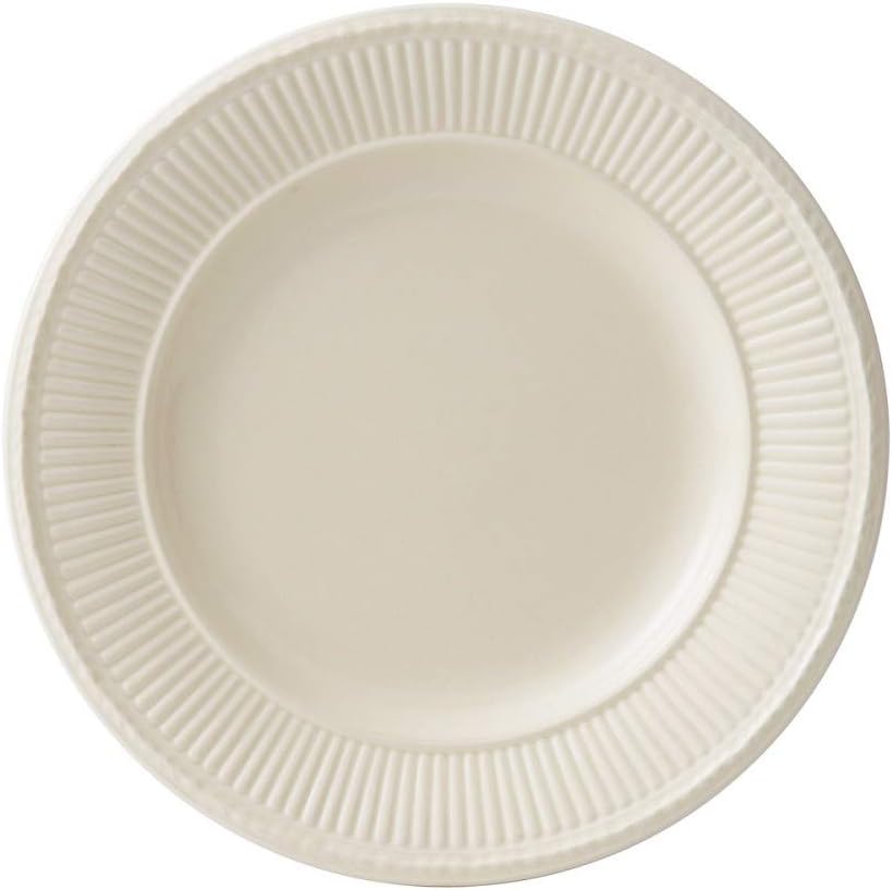 A round, cream-colored ceramic plate with a textured, fluted rim pattern reminiscent of a classic bread basket, viewed from above against a white background.