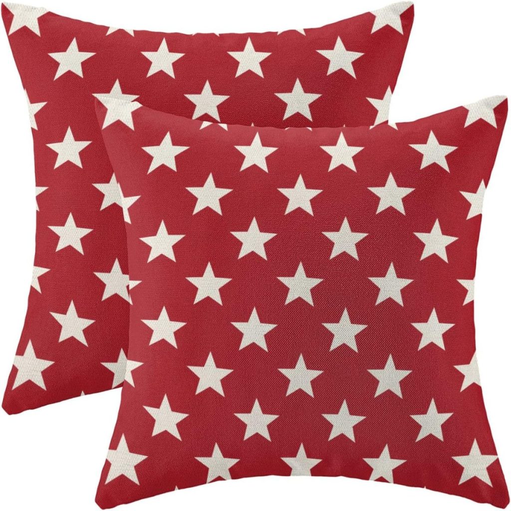 Two red square throw pillows with a pattern of evenly spaced white stars, perfect as patriotic decorations for your home.