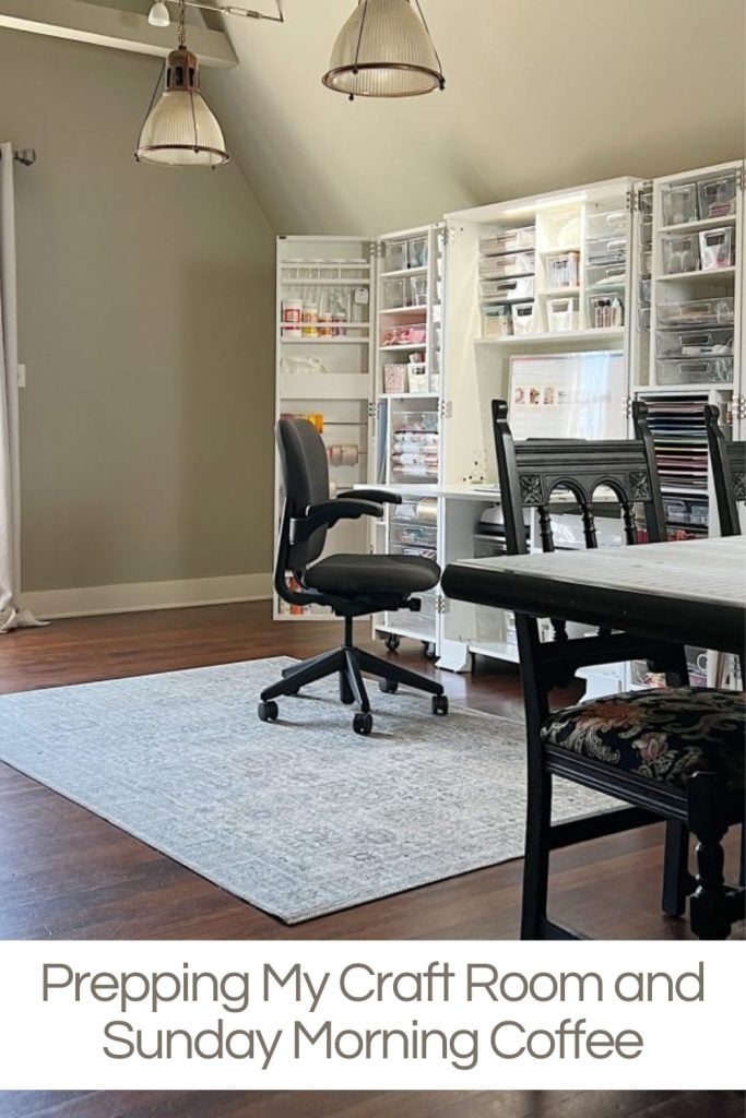 A well-lit room with a crafting station, office chair, organized shelves with supplies, a rug, and a table. Text overlay reads, "Prepping My Craft Room and Sunday Morning Coffee".