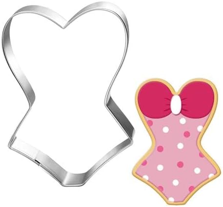 A metal cookie cutter in the shape of a swimsuit sits next to a decorated swimsuit-shaped cookie with pink polka dots and a red top—perfect for pairing with your favorite easy cake recipe.