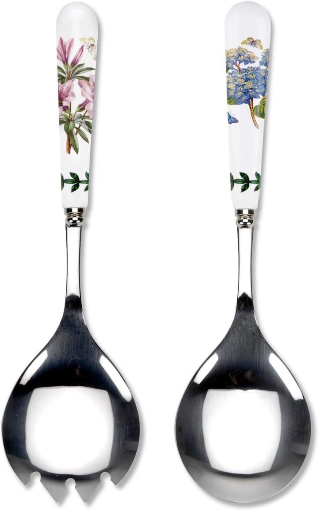 Two stainless steel salad servers with white handles featuring floral designs; perfect for serving your favorite Summer Chicken Recipes. One server has a slotted edge, and the other is a solid spoon.