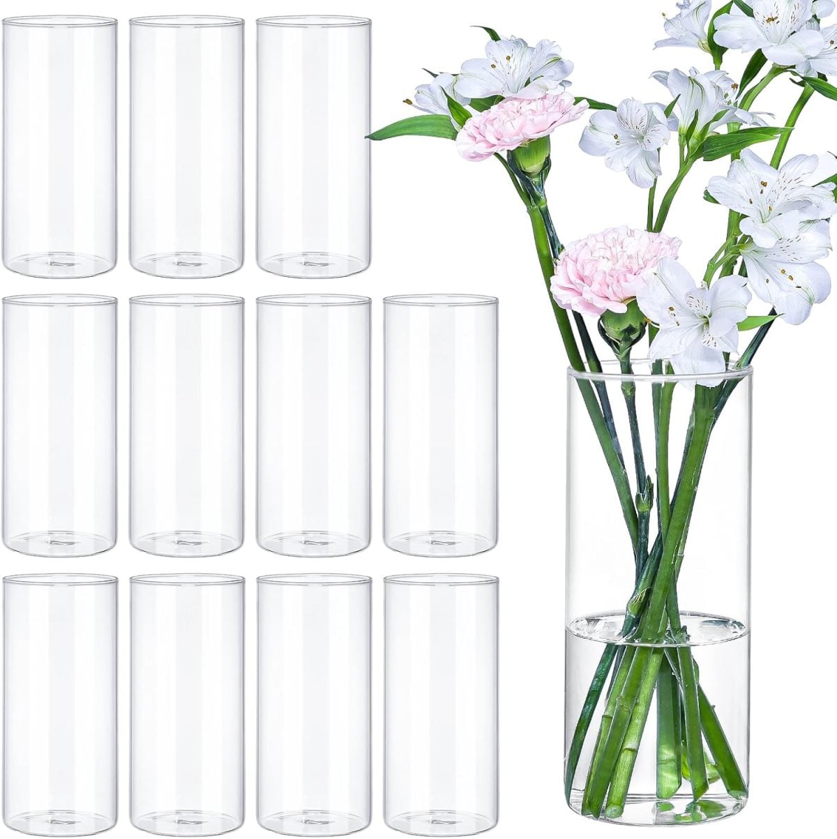 Eleven empty clear glass cylinder vases and one vase with water, white and pink flowers, and delicate pressed flowers arranged vertically.
