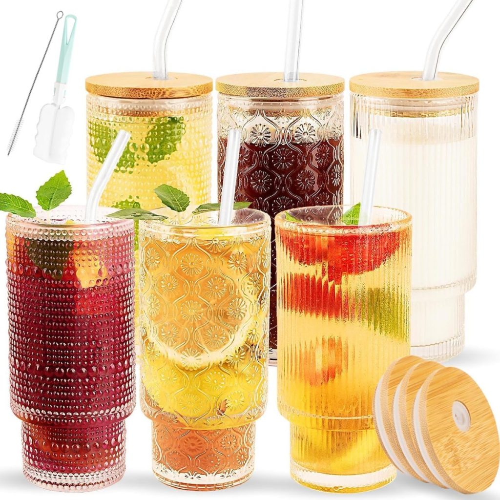 Six textured glass tumblers with drinks, bamboo lids, and straws, shown with cleaning brushes and extra lids—perfect for serving the best iced tea with fresh fruit and mint garnishes.